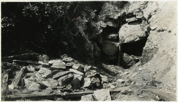 A photograph of fallen rock that appears to have covered a tunnel entrance.