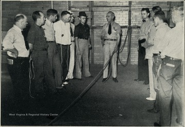 A photograph of a group of men partaking in safety training.
