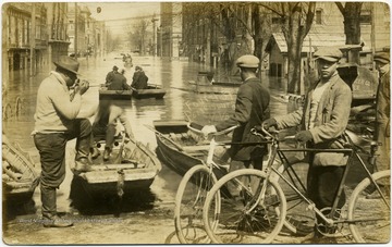 African-American boys with bicycles in foreground.