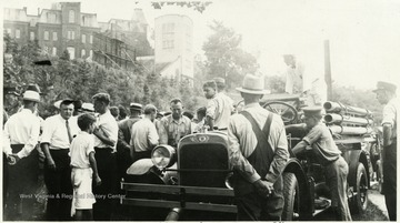 A photograph of a group of people in safety training in Morgantown.  Woodburn Hall is in the top left corner of the photo.