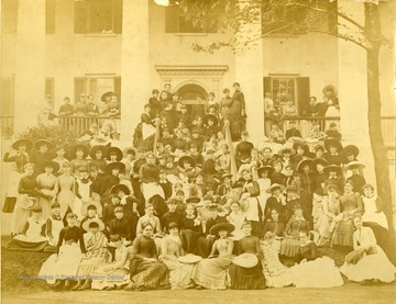 A photograph of a large group of girls in front of a building at what appears to be a finishing school.
