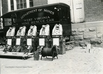 A photograph of safety equipment lined up in front of a Mine Rescue Car from the West Virginia Department of Mines.
