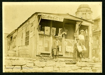 Two African-American Newsboys and Unidentified man stand outside C. N Chilins, located on Madison Ave. Fairmont, W. Va...eventually (relocated) to the first floor of Watson Hotel.