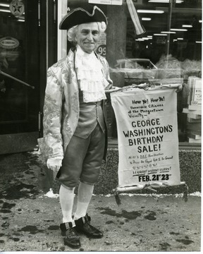 "George Proclaims his day-- George Washington's birthday sale sponsored in Morgantown by the Down Action Council. Russell L. Long, well [known] local impersonator and entertainer, donned the garb of the Revolutionary period and paraded city streets telling everyone about the event."