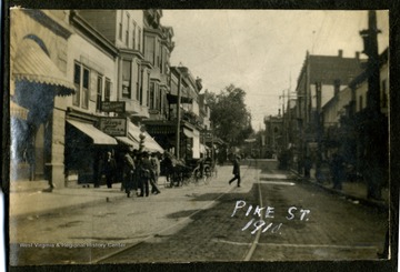 Brick-laid Pike Street, Clarksburg, W. Va.; Streetcar rails visible.