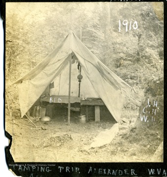 A pitched tent with a few cots. Likely the Hall family.