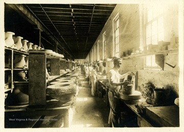 Pottery workers of Bowers Pottery at their work stations.  The Bowers Pottery is formerly Homewood Pottery Company.