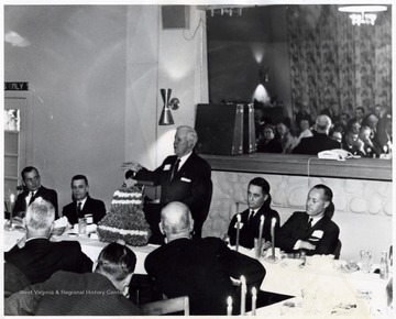A photograph of Harley Staggers giving a speech at a gathering.