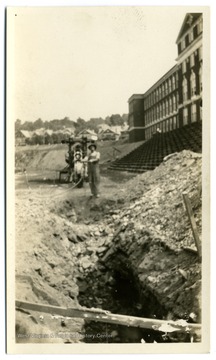 Digging a ditch to lay pipes in the athletic field in a new high school in Morgantown, W. Va..