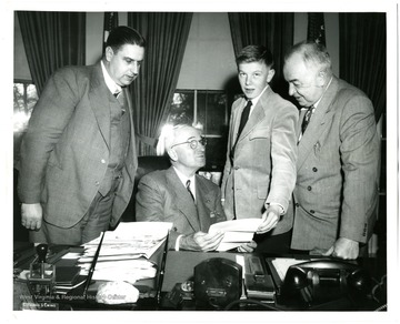 'Federations prize essayist meets President Truman--John Dean, 16, Charleston's Stonewall Jackson high school student who submitted prize-winning composition in the federation's 1947 essay contest, visits President Harry Truman at the White House in company with President E. A. Carter (left) and West Virginia Senator Harley M. Kilgore (right).