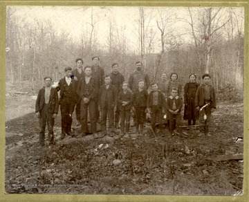 Individuals in the photo: Charley Summers; The Teacher Johnny Smith; Earnest Huffman; Lewie Rosier; Wait Huffman; Will Pierce; Claud Bolyard; Magy Bolyard, Lance; Ona Bolyard; Back: Elza Huffman; Wesley Summers; Noah Shahan; Mr. Morgan Bolyard; Mrs. Morgan Bolyard and Sadie Pierce. 