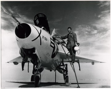 A photograph of pilot Chuck Yeager with his jet plane. 'Charles Yeager, who was born in Lincoln County, became the first person to fly a plane faster than the speed of sound. He is the hero of Tom Wolf's best-selling book, "The Right Stuff," which was made into a popular motion picture.'
