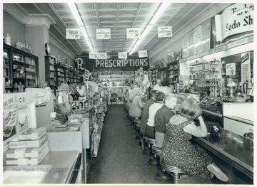 A long view of the interior of Furbee's Rexall Drug Store on West Main Street, Bridgeport, W. Va.