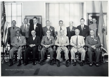 'Escorts: Commander John P. Floyd, USNR, Lt. Colonel H. L. Conner, USA; Sitting, Left to Right: Walter Aiken, H. R. Baukhage, Meyer Bernstein, Tams Bixby, Jr., Dr. H. C. Byrd, Harry De Butts; Standing, Left to Right: Commander John P. Floyd, R. MacGruder Dobie, Robert Estabrook, E. J. Forio, Kent Hunter, Julius Klein, James Lucas, Lt. Col. H. L. Conner'