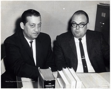 A photograph of Richard Dasher (right) sitting with an unidentified man.