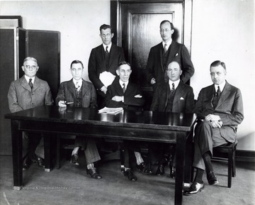 'Left to right, seated: Maj. Gen. Charles McKinley Saltzman, newly appointed member of the Federal Radio Commission representing the fourth zone; Judge Eugene O. Sykes, representing the third zone; Judge Ira. E. Robinson, chairman, representing the second zone; Harold A. Lafount, representing the fifth zone and William D. L. Starbuck, newly appointed, representing the first zone. Standing, Carl H. Butman, secretary of the commission and Bethuel Webster, general counsel to the Commission. The Federal Radio Commission composed of these men is now in special session considering radio legislation.'