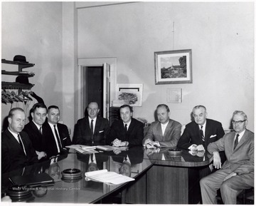 A photograph of the Board of Directors, including E. E. Hamstead (second from right) and Jim Rich (fourth from right).
