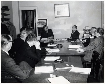 A photograph of a board meeting.  Among those pictured are Samuel Hayden (far right) and Lloyd C. Neilson (fourth from right).