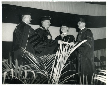 From left to right 1) Unknown 2) Harold Stassen 3) Unknown 4) President Irvin Stewart.