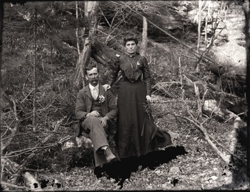 A portrait of a couple taken on a hillside.