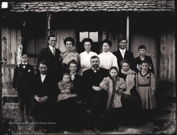 Photographer U. C. Shock moved his family from Helvetia to Arkansas around 1907 where his daughter Bess met Roscoe East. Roscoe and Bess are standing on the left in the photo.  They were later married and had three children.  Herbert Shock is standing on the left while his mother Mary is seated in front of Bess holding her son Charles.  Rilla Shock is standing on the right.  U. C. Shock later moved his family, less Bess, back to W. Va.