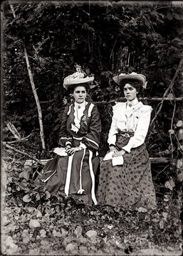 A portrait of two young women taken outdoors. 