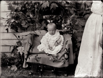 A portrait of infant in chair.