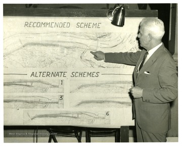 Unidentified man points out an area on a map.