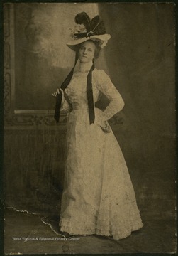 Victorian Era portrait of young woman wearing a high neck, lace dress. Inscribed on the back, 'Hold till mats are sent in McKendry'