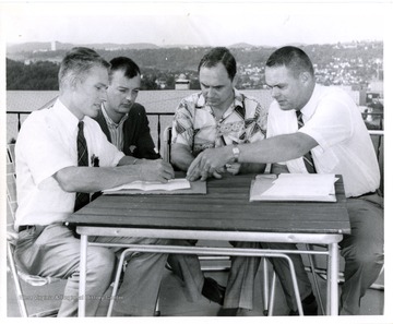 Group of men at patio table.