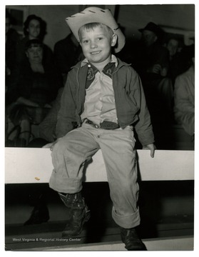 A portrait of unidentified boy in cowboy outfit.