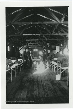 O. McIntire, Welch, J. Morse, W. Grenpis, Hood and Cross inside of barracks. 