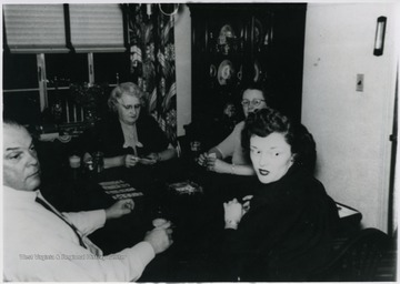 'Around table clockwise from left- Walter Gerard Blume, Irene Keefe Blume, Margaret Helen Blume, and Mary Dorothy Blume.