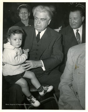 John L. Lewis holds a boy.