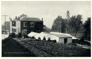 'Showing the rear of the Experiment Station Building and the Greenhouses.'  This photo is from a booklet, 'West Virginia University and its Picturesque Surroundings,' 1901.
