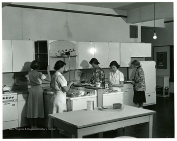Students of Home Economics work in a modern, well-equipped lab.