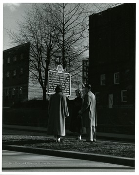 Students stop on the Grumbein Island which is a narrow strip of land on Campus Drive between Mountainlair and Woodburn Circle; it is one of several landmarks on the Downtown Campus.