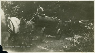 '45 horse power first boiler being hauled from Clifton Run, W. Va. across the mountain to Kerens and into Montes, W. Va., across the mountain to the bandmill set on Clover Run where the boiler was used as one of the units for making steam in the bandmill. For this haul of boiler 4 horses were on the front and FWD truck pushed with a push pole.'.