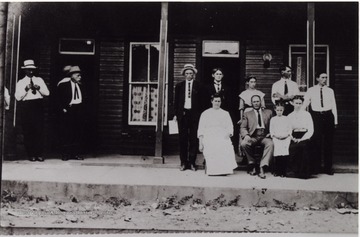 Portrait of group in front of the hotel. Later became the Clifton Hotel.