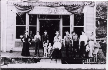 Group posed on the porch in front of the store.