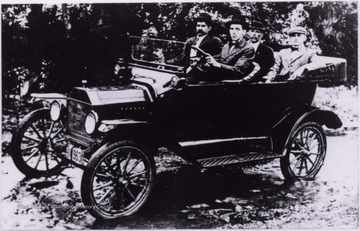 "Front: Unknown and Oliver Borne, driver. Back: Bernard Herron and Walter Arbogast."