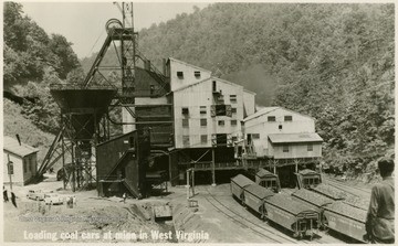 On the front: "Loading coal cars at mine in West Virginia."