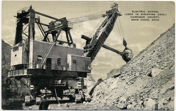 On the front: "Electrical Shovel (used in stripping coal) Harrison County near Cadiz, Ohio."On the back: " Size of the shovel: Dipper holds 16 cubic yards; boom 97 feet 6 inches long; dipper handle 64 feet; overall height (at Gantry) 90 feet; Shipping weight 3,250,000 pounds."