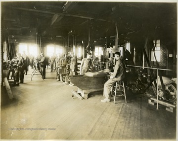 This portrait shows soldiers at work on various machines.