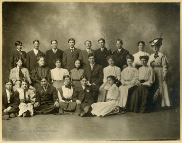 From "Beckley U.S.A." by Harlow Warren, p. 379, vol. 2. Back row, left to right: Azel Riffe; Bernard Curtis; Ritchie Callaway (Ken's brother); W. A. Riffe; Willis West; Charles Aliff; Lewis Peters; Elsie Curtis; Minnie Ogden. Middle row, left to right: Henrietta Callaway (Mayor W. W. Payne, Huntington); Pearl Callaway (James Caudell); Anna McDowell; Lida Pine (Tolifer?) C. O. Dunn; Myrtle Robertson; Daisy Tench (Bill Shannon, Florida); Hattie Shumate. Front row left to right: Giles Fink; Locia Fink; Dr. Shirley Callaway, (Dentist); Dorcas Ogden; A. Ray Fink; Miss Hila Richardson" (p. 379). At the time, Marshall University was known as Marshall College.