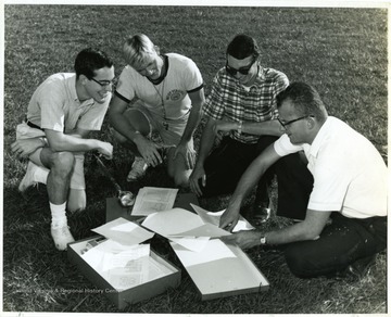 Members and staff looking over formations.