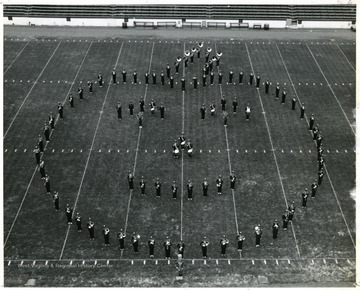 WVU Marching Band performs halftime field show. Formation in the shape of a pumpkin.