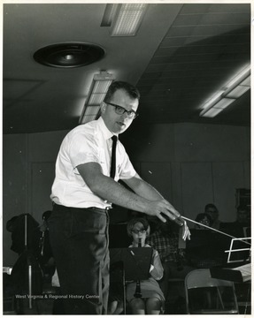 Band director Budd Udell conducting.