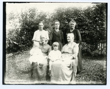 Left to right: Alma Betler Burky, Lizette Stadler Kuenzler, Lena Dubach Kuenzler. Seated: Elise Dubach Burky, Marianna Dubach Aegerter. Children: Norman Burky, Irene Burky.