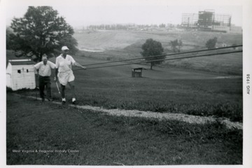 R. C. Spangler and other golfers.  WVU Health Science Center building under construction in background.